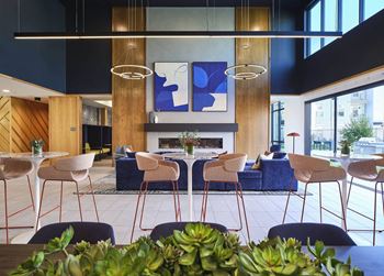 the lobby of a hotel with tables and chairs